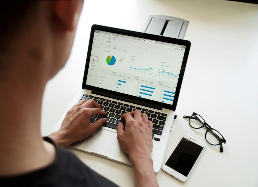 People reviewing information together around a laptop